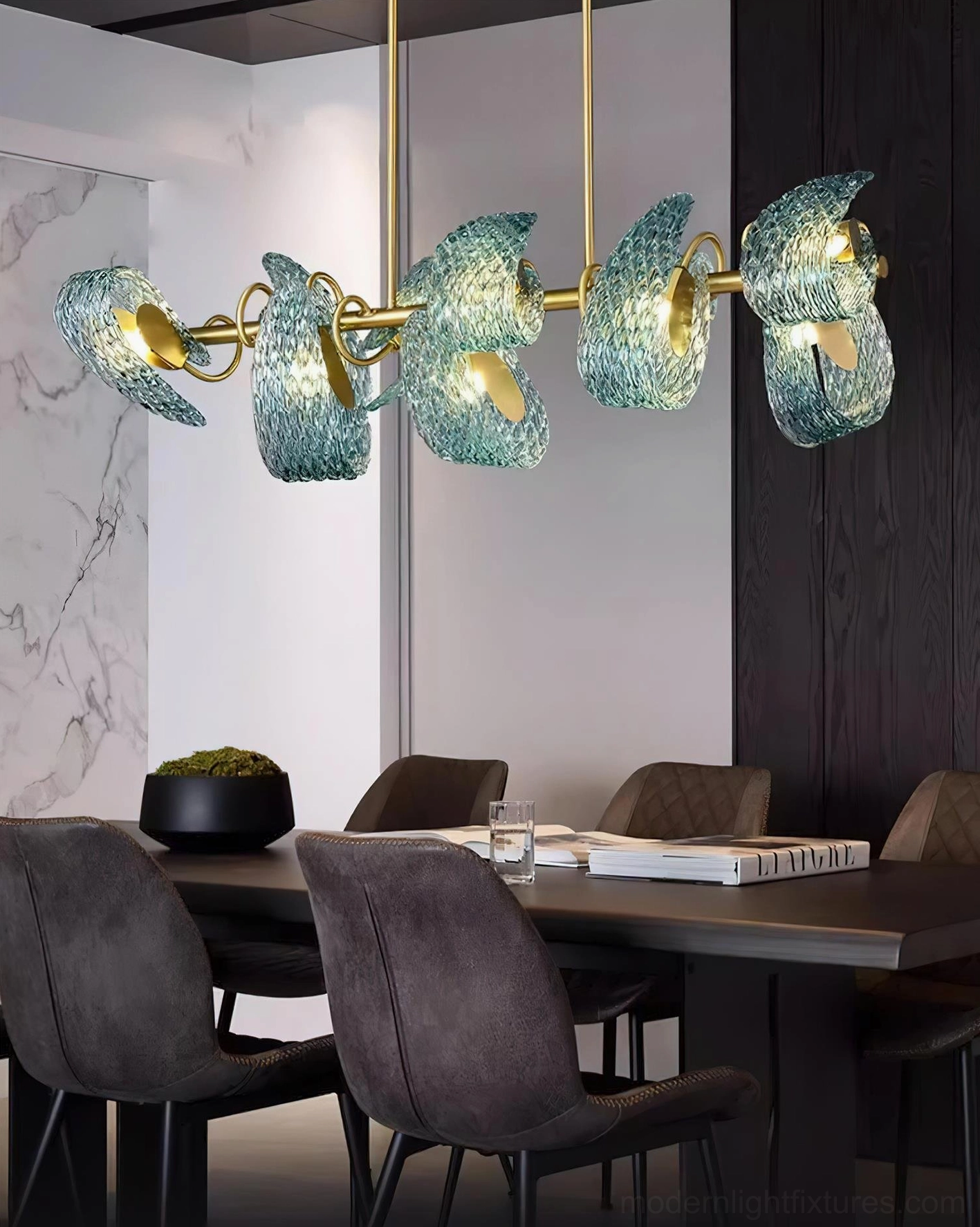 Virello modern dining room chandelier with brass gold metal structure and blue wavy glass shades, side angle view