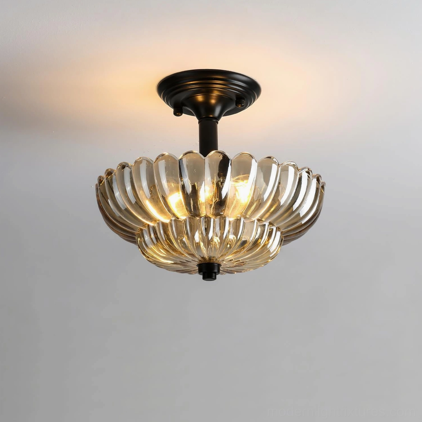 Virenza modern ceiling light fixture close-up, illuminated scalloped glass shade with warm amber tone, detail photography