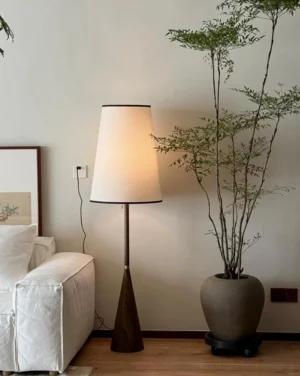 Viresto floor lamp with linen drum shade in minimalist living room corner beside sofa