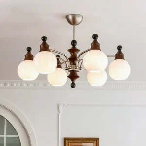 Multi-head frosted glass round pendant chandelier installed in minimalist white interior, showcasing warm ambient lighting