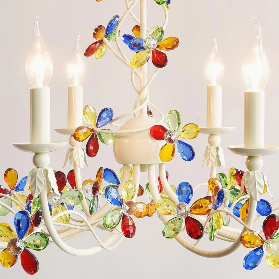 Vivette floral chandelier with lit candle-style bulbs creating warm ambient lighting effect