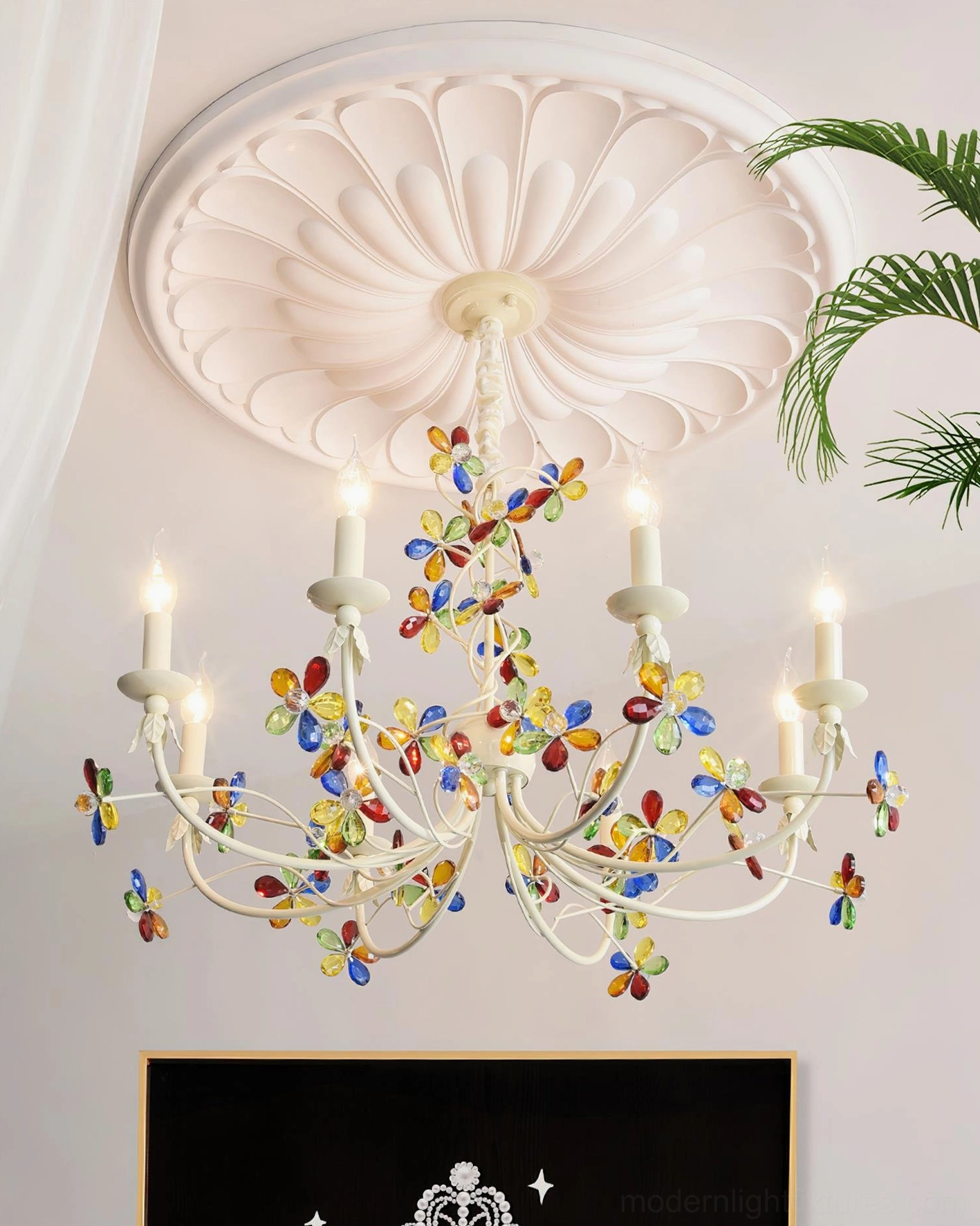 Vivette floral chandelier with colorful glass flowers and lit candle bulbs in modern interior design