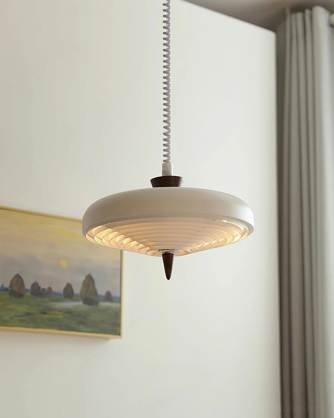 White spiral pendant fixture in gallery-style interior with landscape painting and contemporary décor