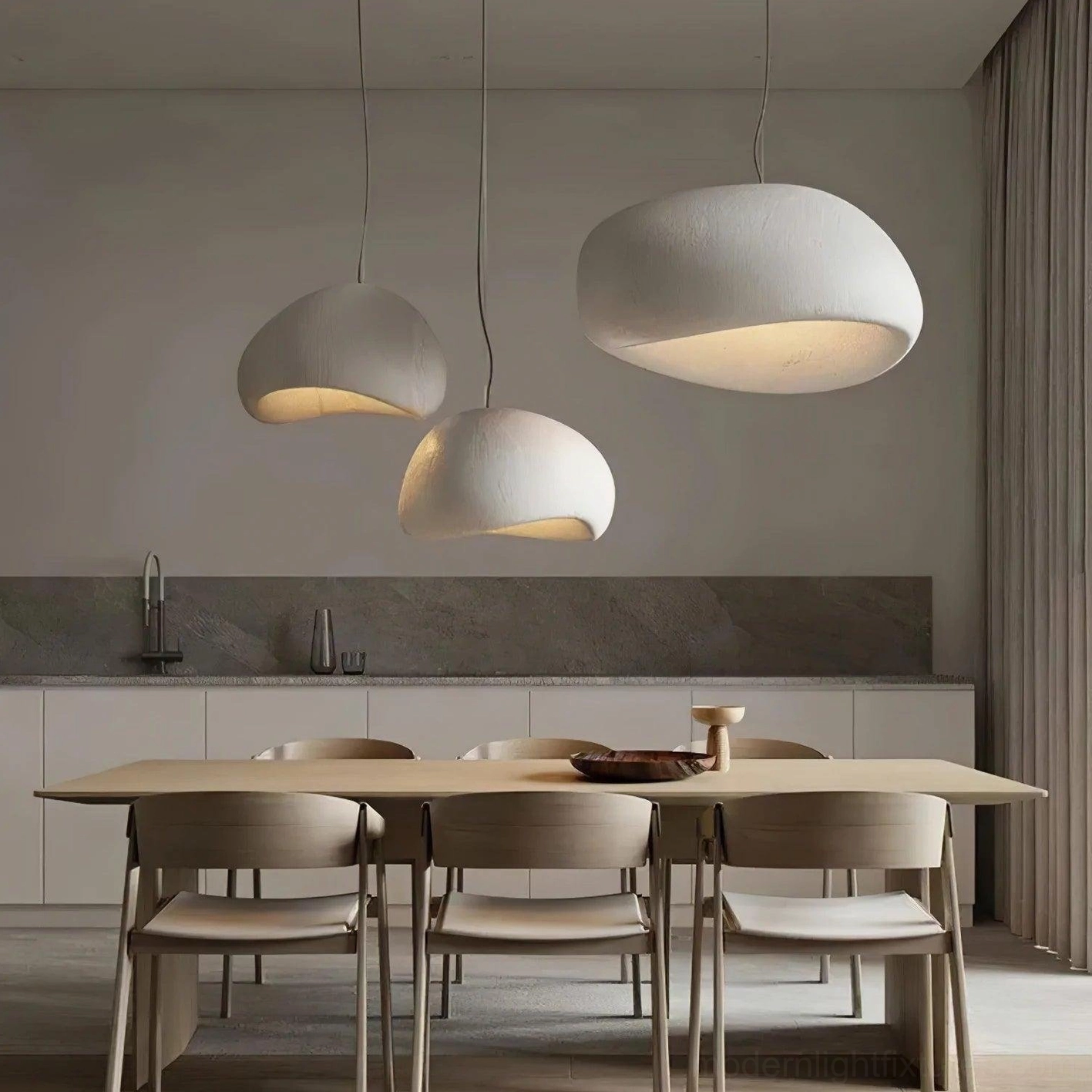 Multi-head wabi-sabi pendant chandelier illuminated above dining kitchen space