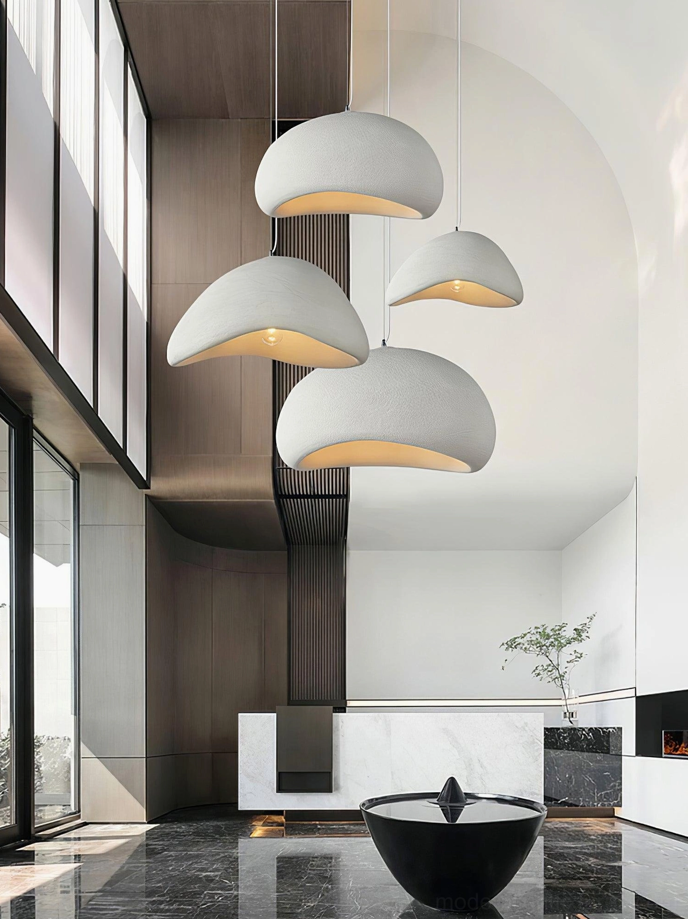Grey wabi-sabi pendant chandelier in double-height minimalist interior with natural light