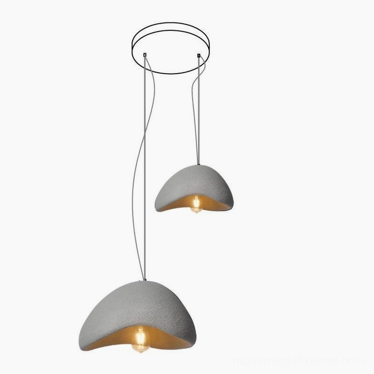 Grey wabi-sabi pendant chandelier with warm exposed bulb creating intimate dining atmosphere
