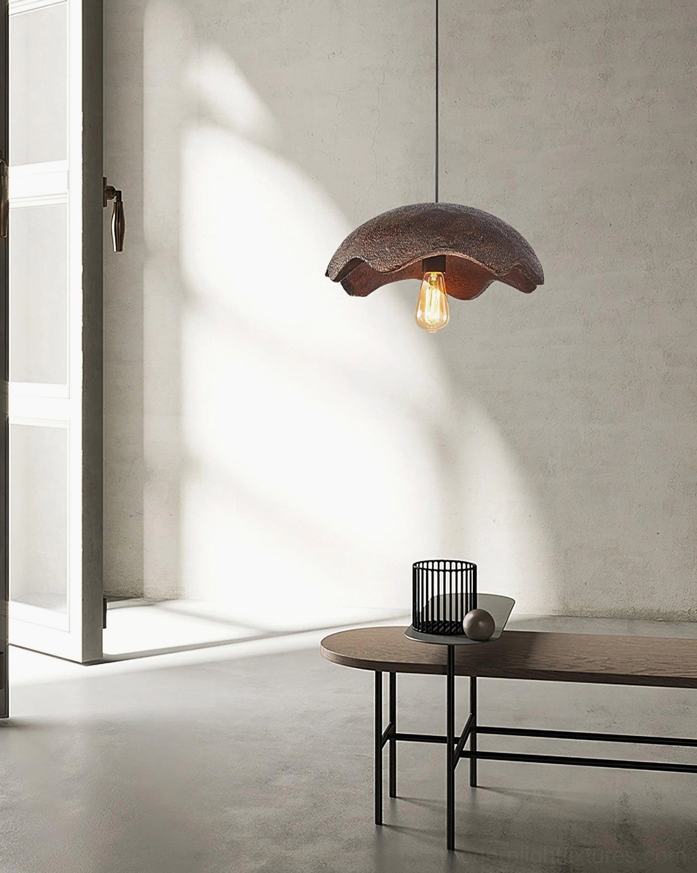 Wabi-sabi scalloped pendant light in red above side table in sunlit minimalist corner space