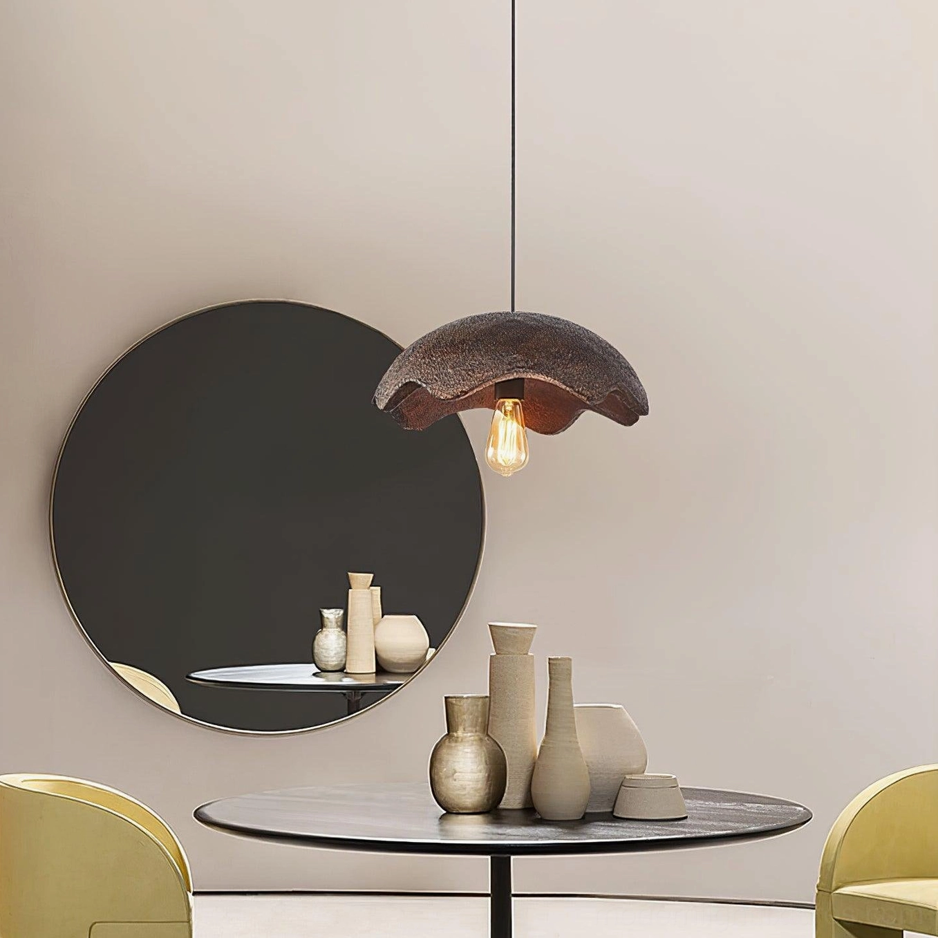 Wabi-sabi red pendant light in minimalist vanity area with round mirror and decorative objects