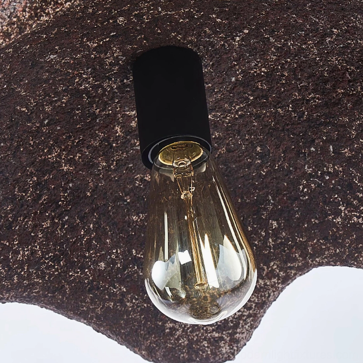 Wabi-sabi red scalloped pendant light with warm glow creating cozy minimalist ambiance