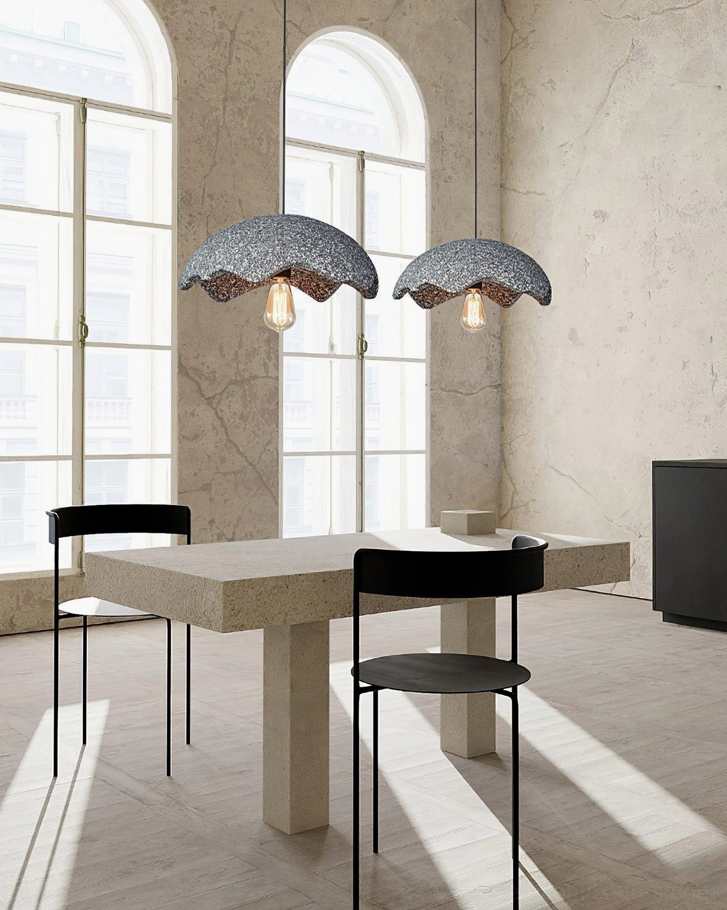 Pair of wabi-sabi gray scalloped pendant lights in minimalist dining room with windows