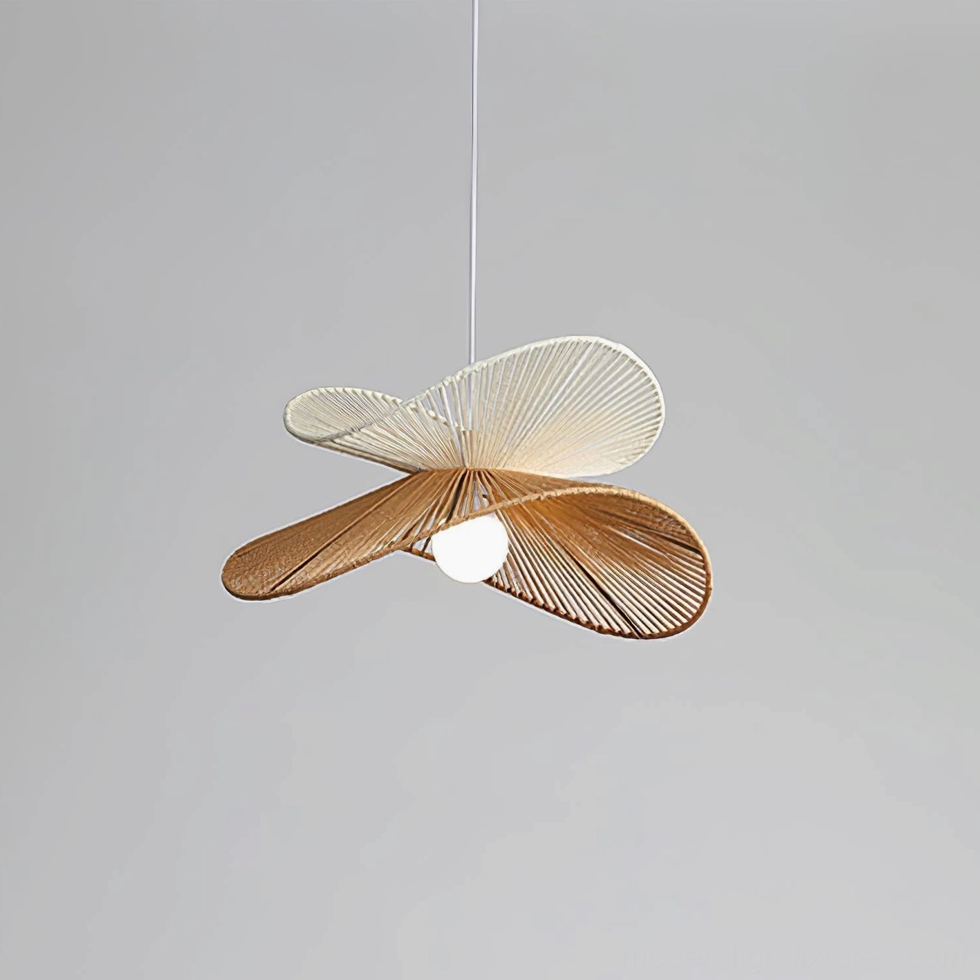 Rattan pendant light hanging in contemporary minimalist interior with warm wabi-sabi aesthetic