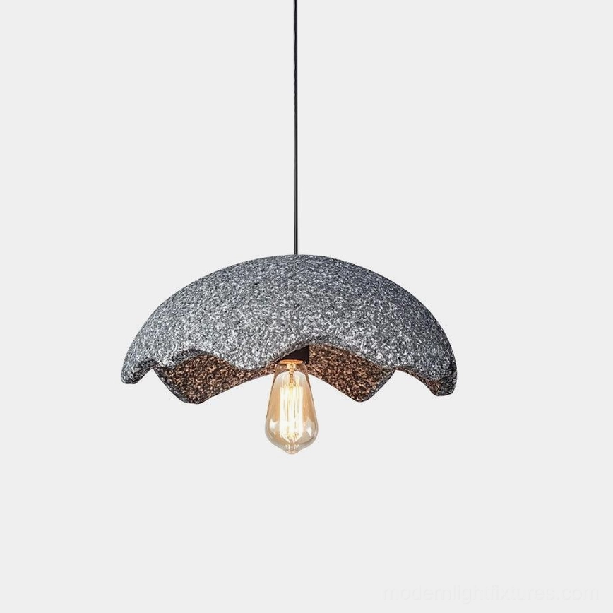 Wabi-sabi scalloped pendant light with dark gray textured shade and exposed Edison bulb on white backdrop