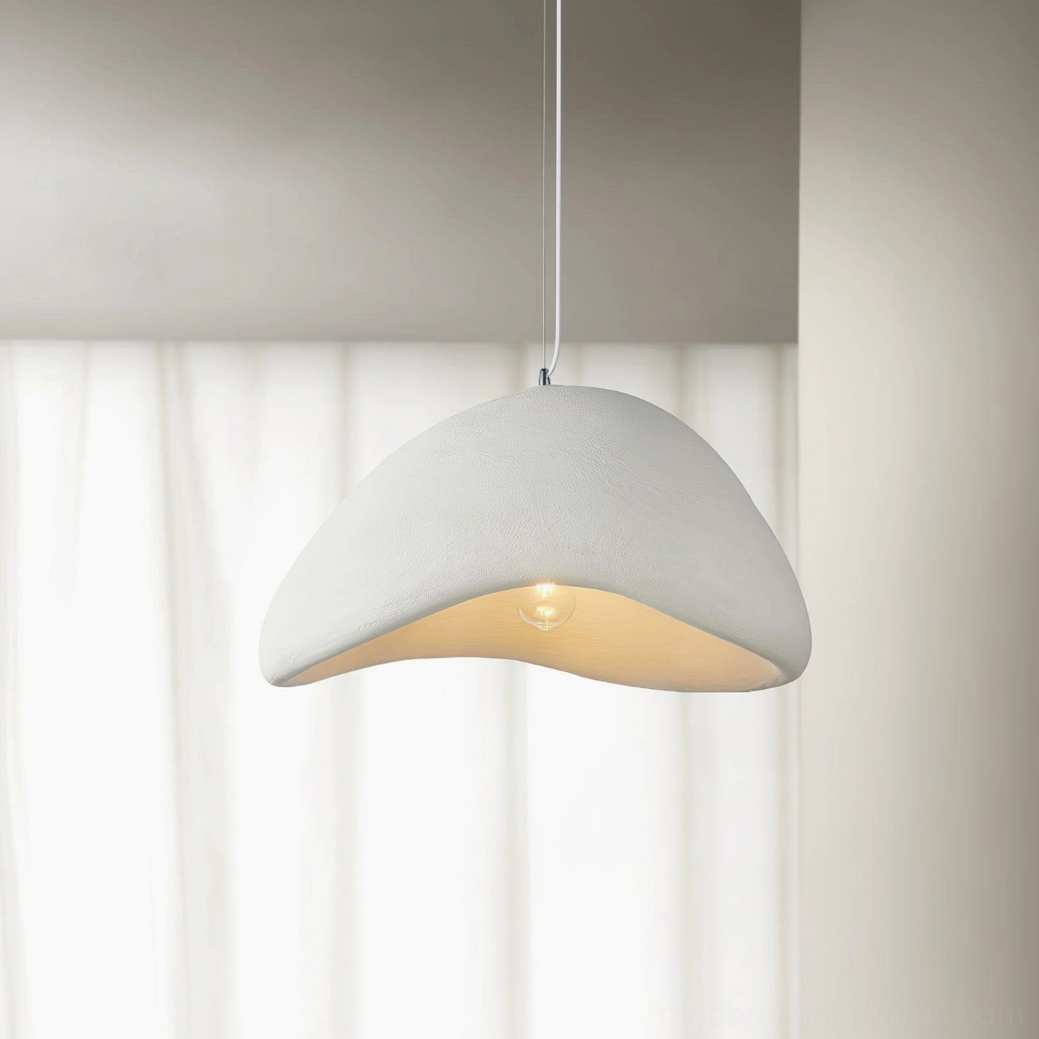 Off-white wabi-sabi pendant light with matte finish and exposed bulb under sheer curtains