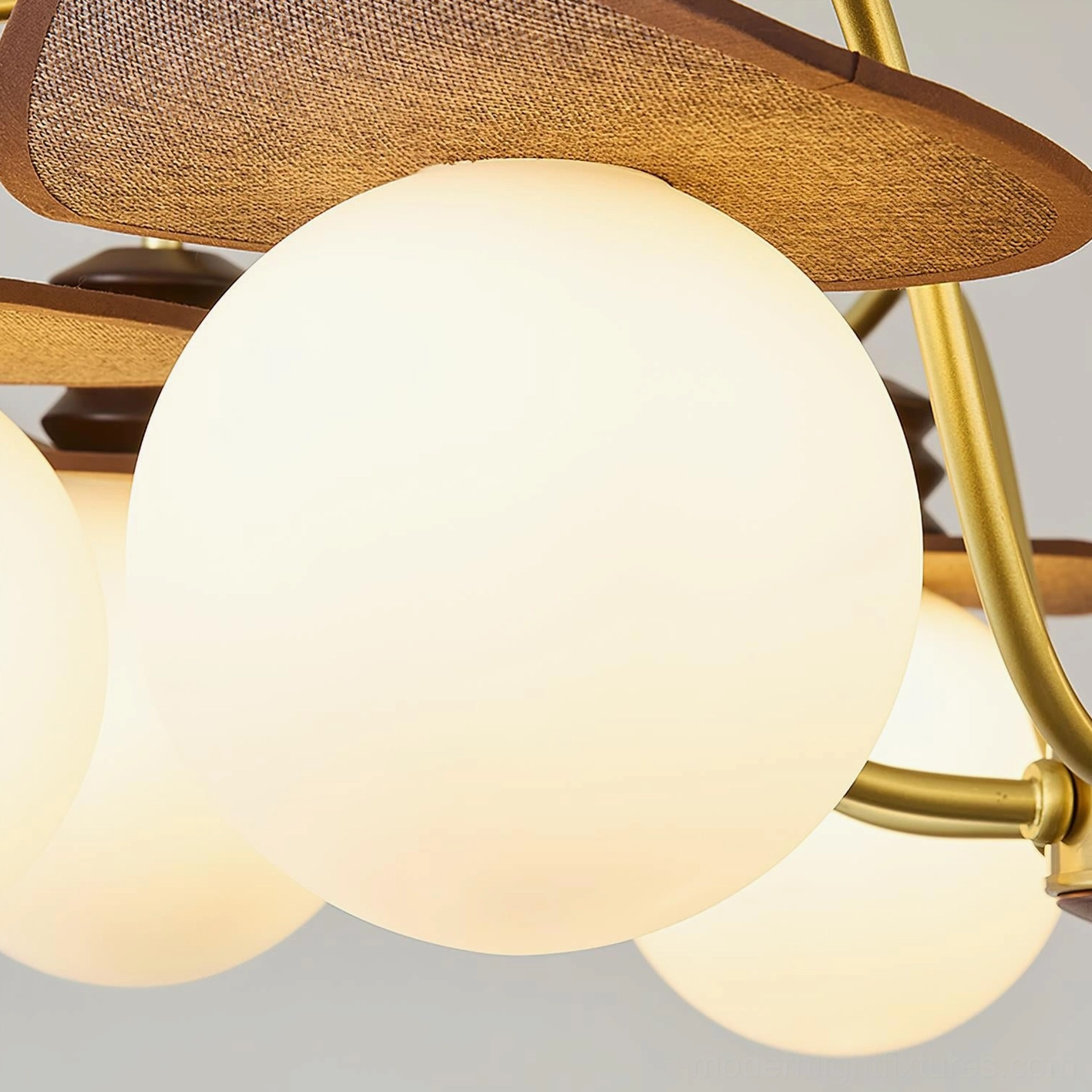 Walden modern pendant chandelier illuminated overhead view showing light diffusion through frosted glass and fixture geometry