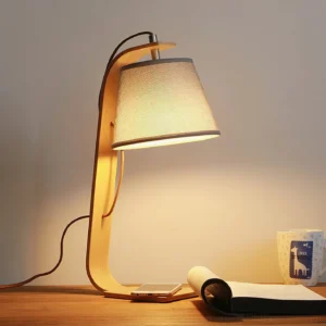 Walden Nordic wooden table lamp illuminated on home office desk with warm light and complementary decor