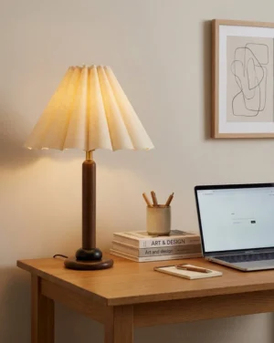 Waldena wood and fabric bedside lamp styled on home office desk with laptop and design books