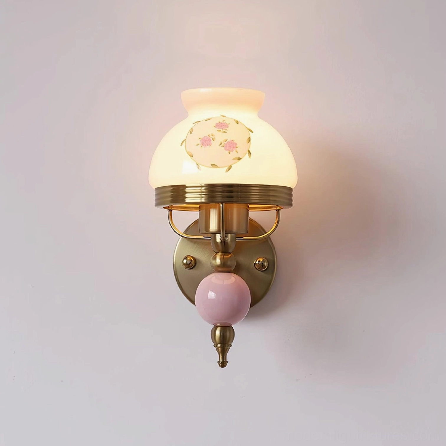Close-up of retro wall lamp frosted glass shade with delicate floral décor and brass hardware