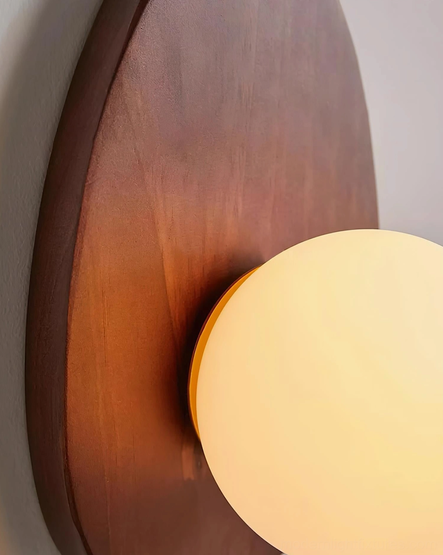 Mid-century wall lamp in walnut finish positioned in gallery wall arrangement with artwork
