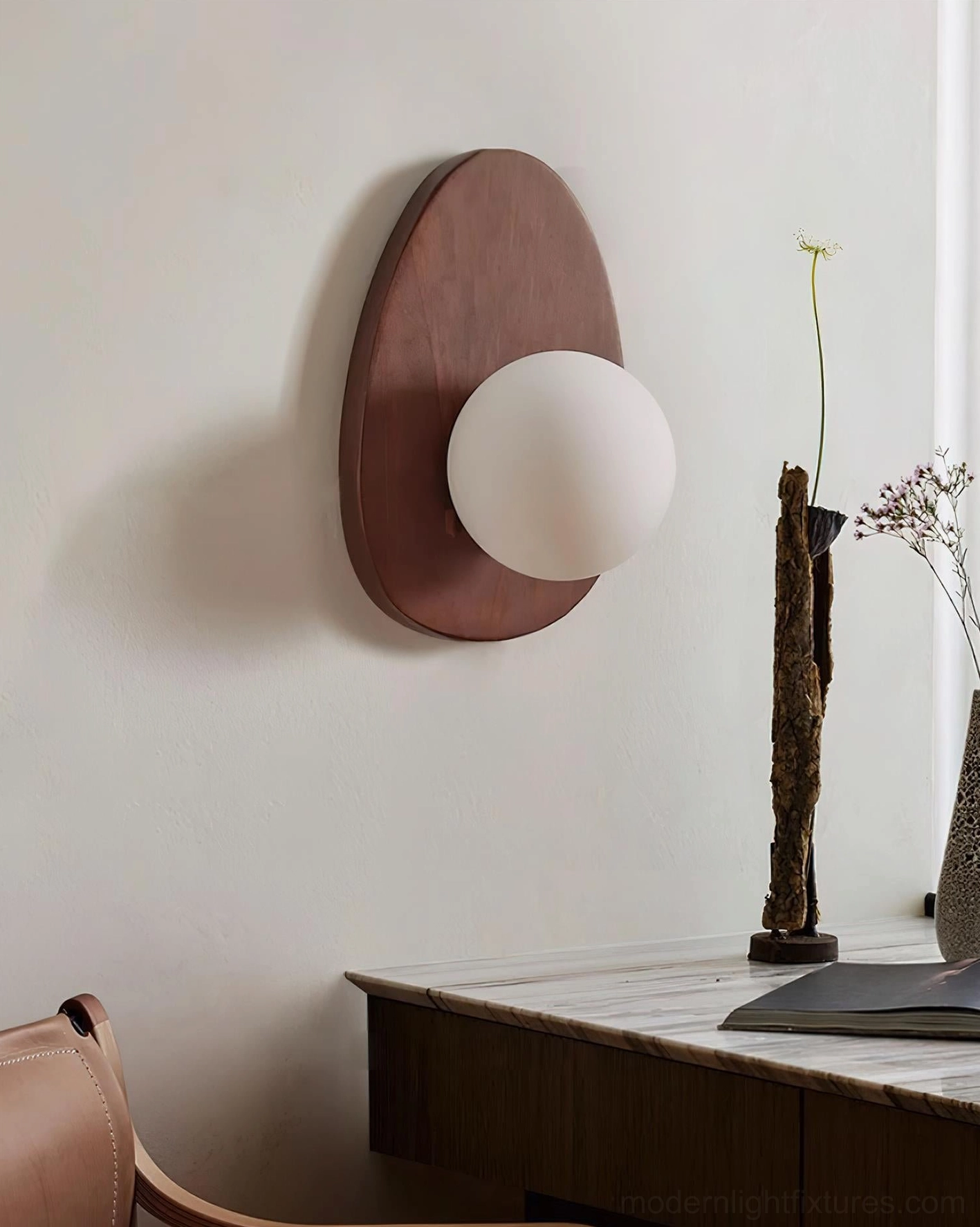 Plug-in wall sconce installed above console table with styling accessories, entryway lighting solution