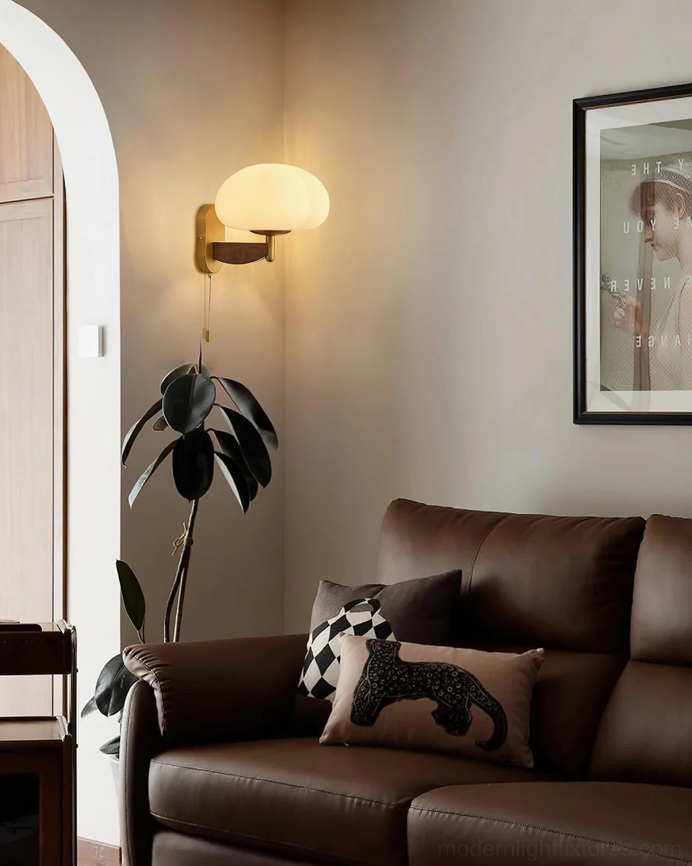 Vintage-inspired wall sconce lighting in retro living room setting with warm glow above brown leather sofa