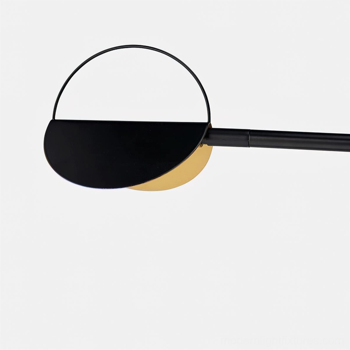 Close-up detail of semi-circular wall sconce head showing minimalist black and gold finish craftsmanship