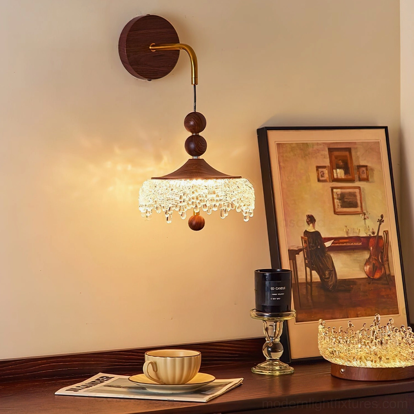Modern wall sconce lit in contemporary home interior with framed artwork, tableware and candle for stylistic context