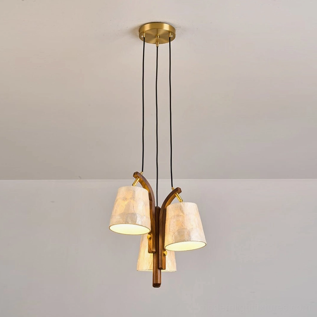 Walmere pendant light illuminated at night showing warm pearly glow through capiz shell shades