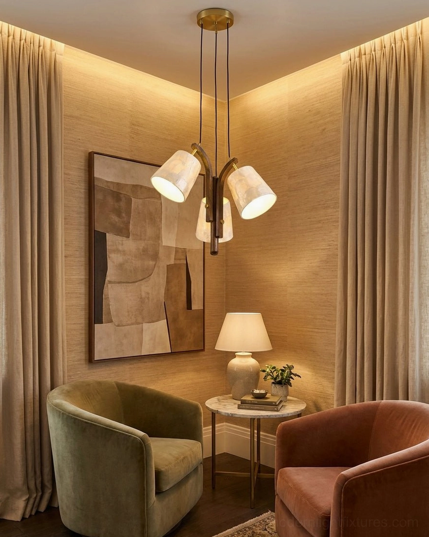 Walmere pendant light over modern living room lounge area with velvet seating and contemporary wall art