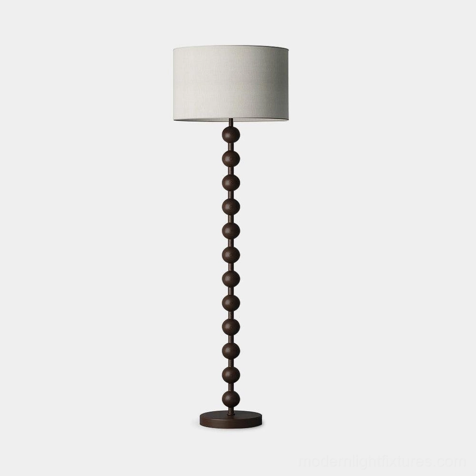 Dark walnut barbell wood floor lamp full body view with cream fabric shade in studio lighting