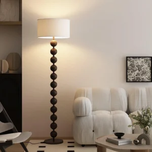 Walnut barbell floor lamp illuminated in modern living room beside sofa and side table