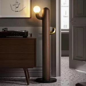 Walnut color wooden cactus floor lamp with integrated coat hook, side profile view in retro hallway showing warm incandescent lighting and mid-century modern style