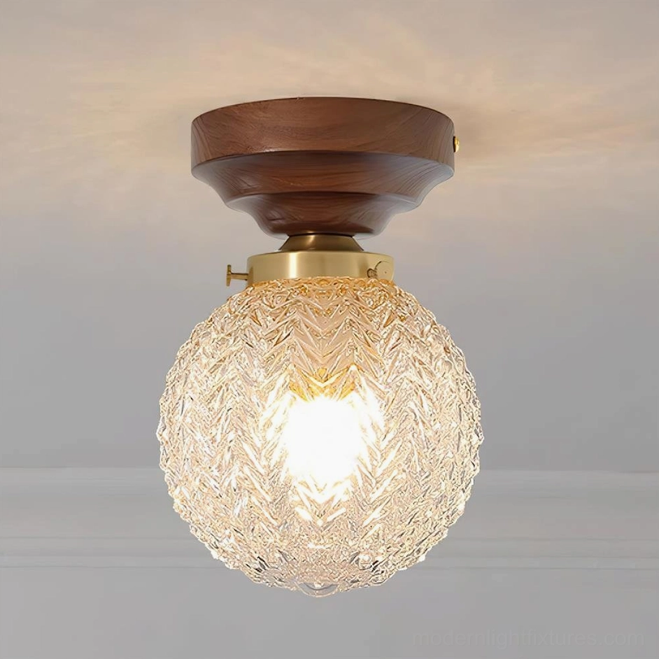 Walnut color textured glass ceiling light fixture with clear glass sphere and brass hardware detail