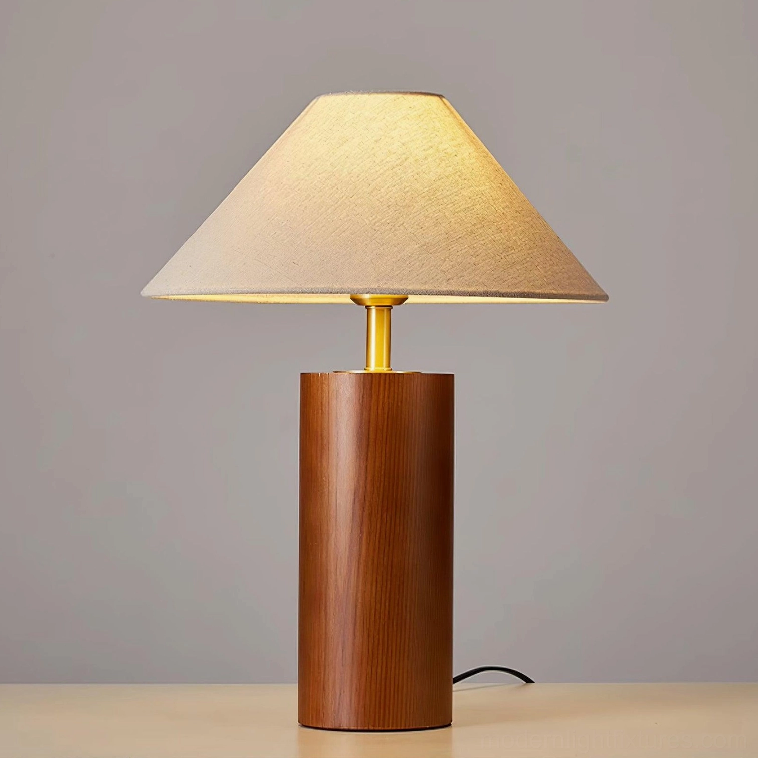 Walnut finish cylindrical table lamp with brass metal stem in home display environment