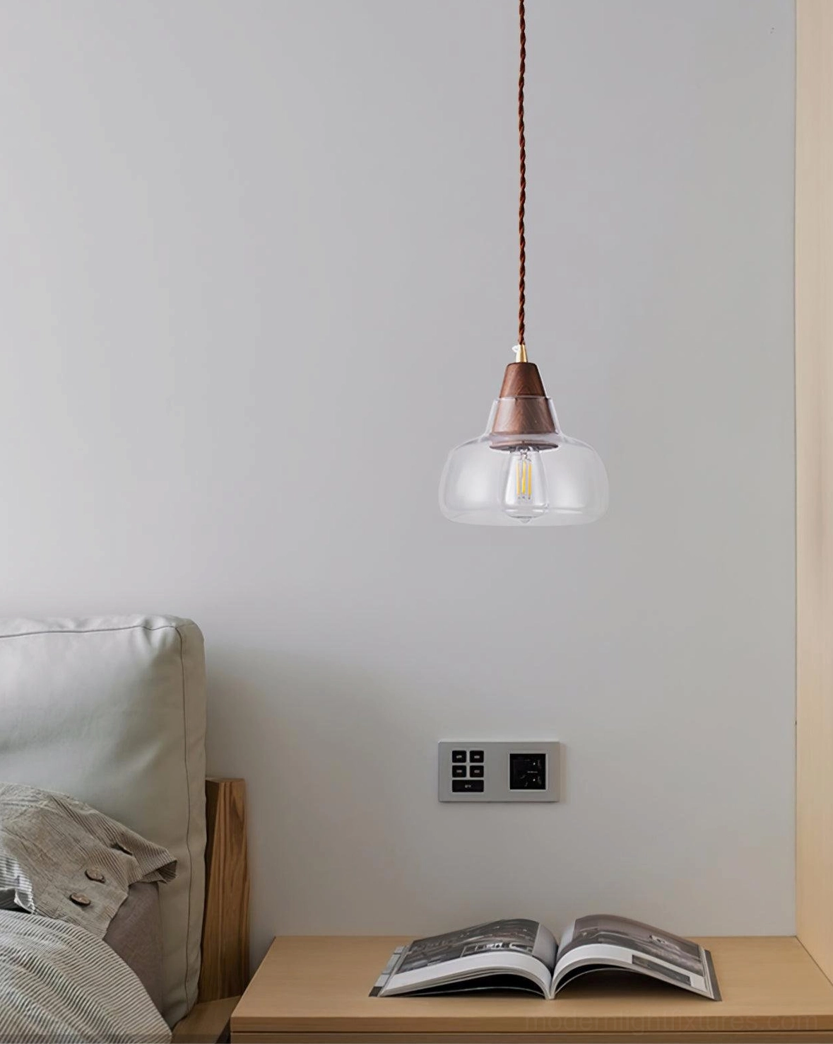 Walnut glass pendant light in neutral bedroom bedside nook with open book on wooden side table, soft reading lamp