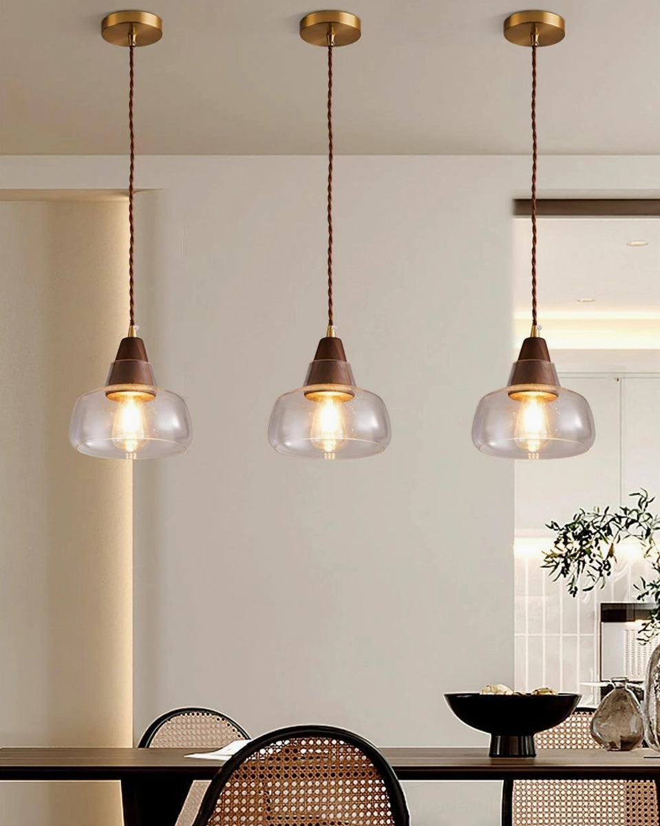 Walnut glass pendant light suspended in contemporary interior, warm luminous quality and natural material authenticity