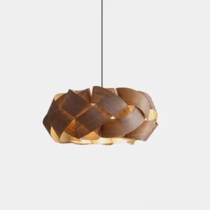 Hand-woven walnut wood pendant light with donut-shaped shade and matte black canopy, front studio view