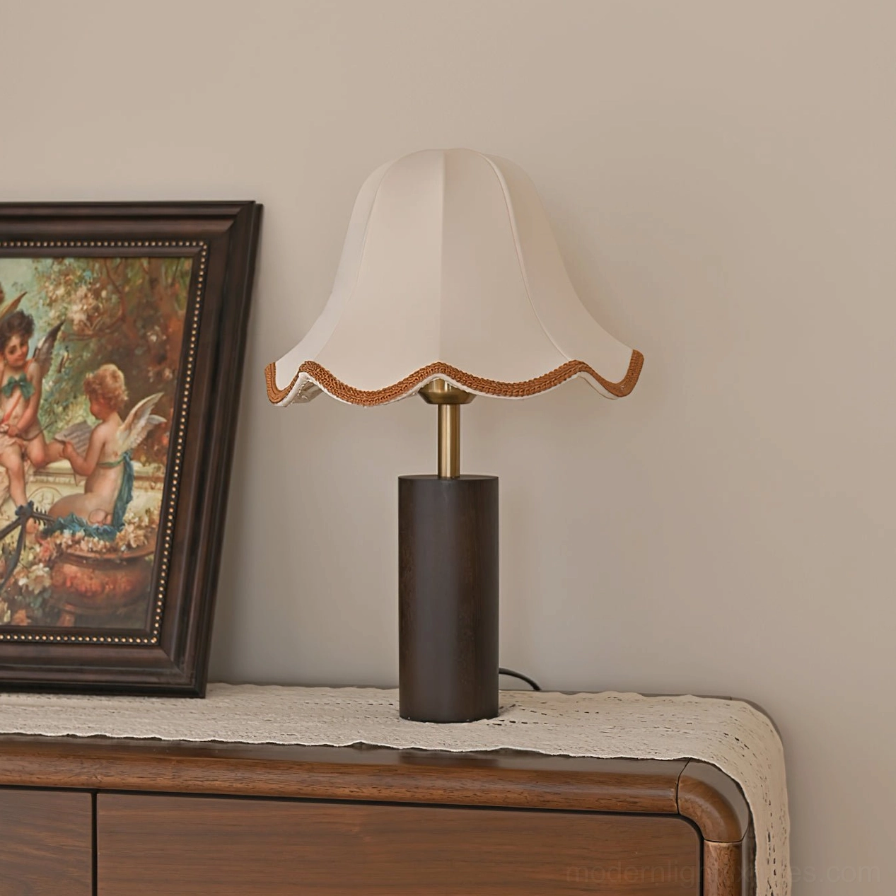 Walnut wood table lamp with scalloped fabric shade showing sculptural wooden base and brass trim details
