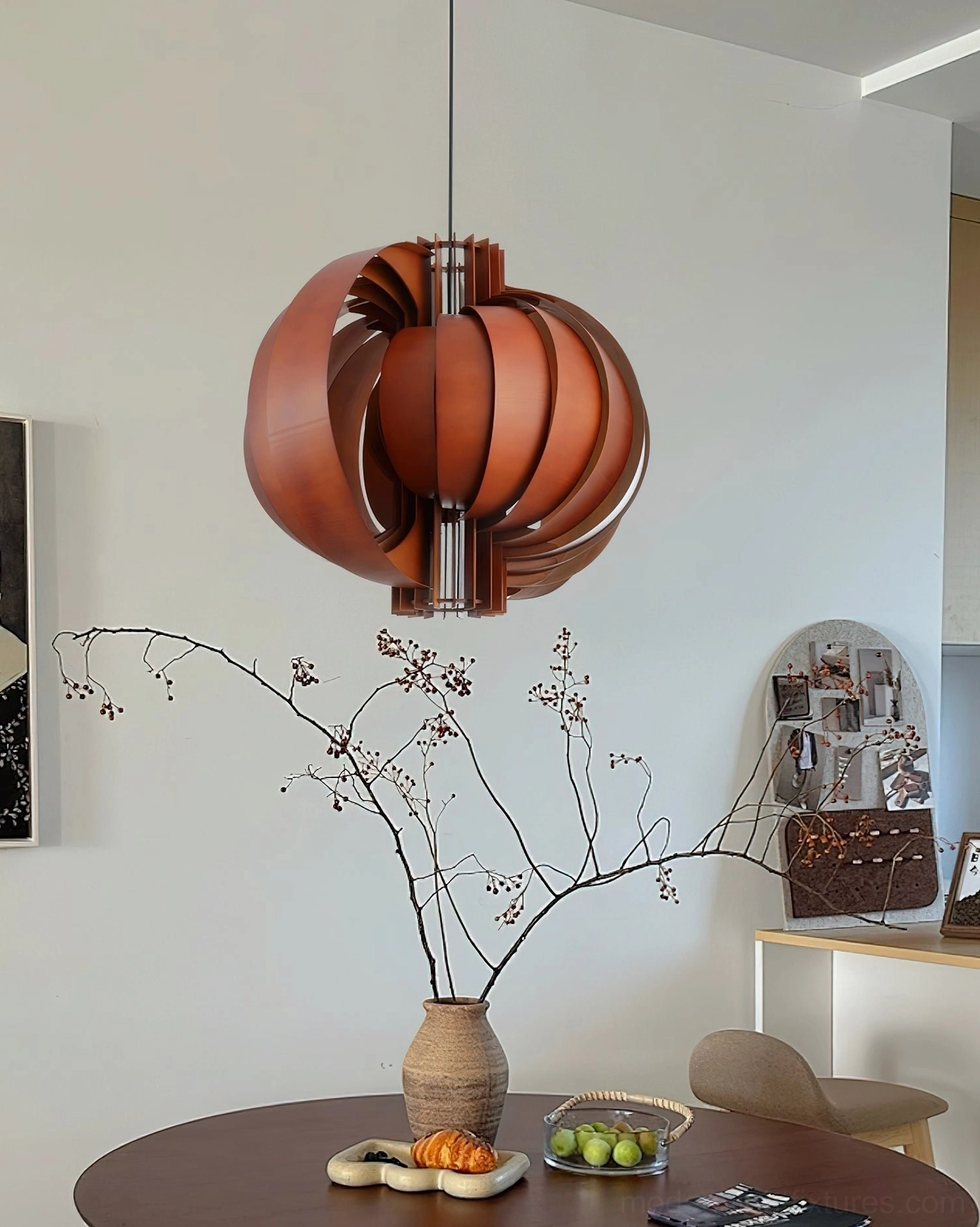 Dark walnut wooden lantern pendant light suspended above dining table in mid-century modern room setting