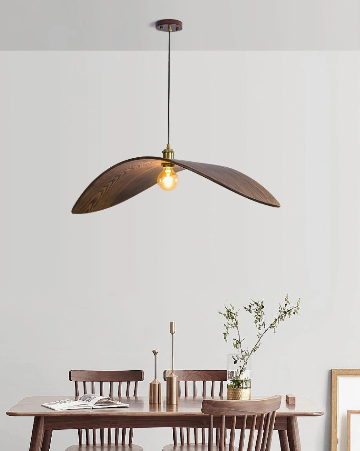 Walnut wood leaf pendant lamp installed in contemporary kitchen or dining space with natural illumination