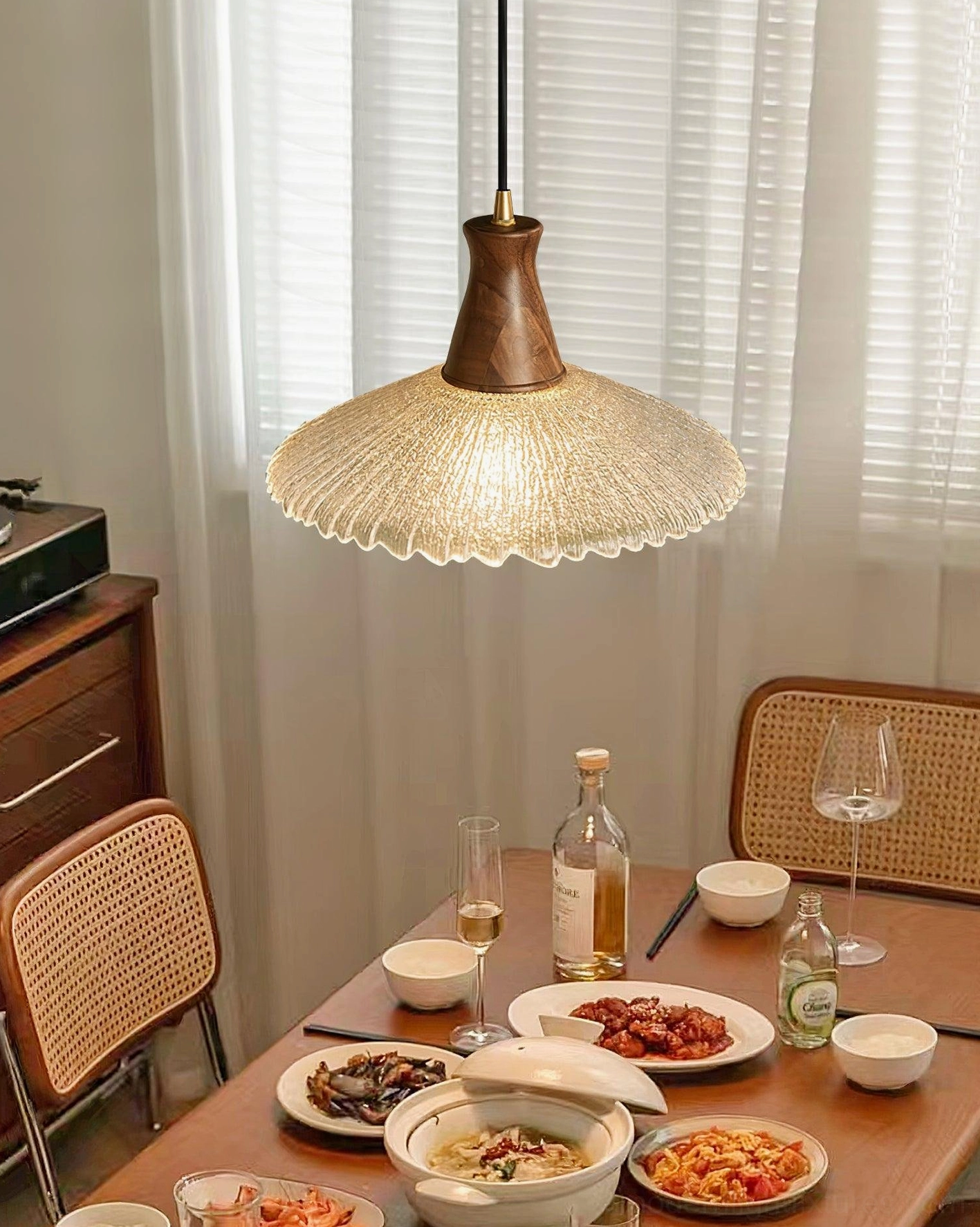 Dining table pendant light with warm glow creating ambient illumination in contemporary home setting