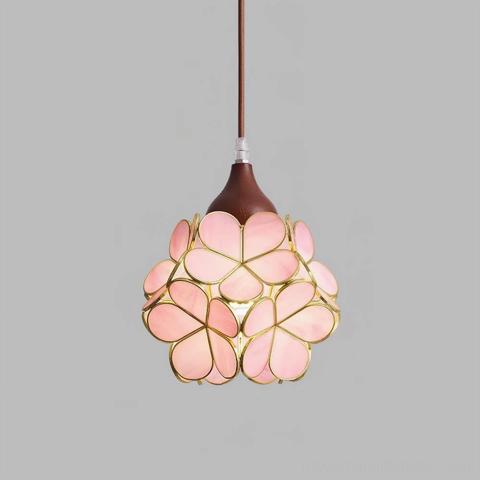 Walnut color and pink stained glass flower pendant light detail, front-facing view of artisan botanical design