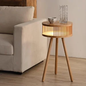 Walnut color side table floor lamp in contemporary living room beside sofa, three-quarter view with glass decor and ceramic items on drawer