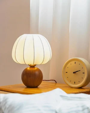 Walnut table lamp ceramic base detail with pleated fabric shade close-up craftsmanship