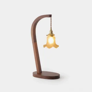 Walnut wood table lamp with curved stem and frosted glass shade, three-quarter front view studio