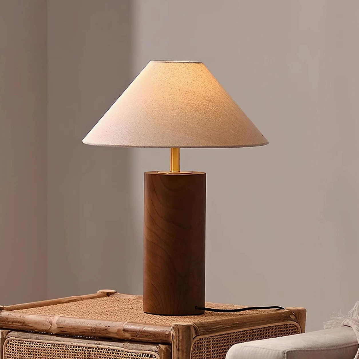 Dark walnut wood table lamp displayed on woven rattan side table in neutral minimalist room