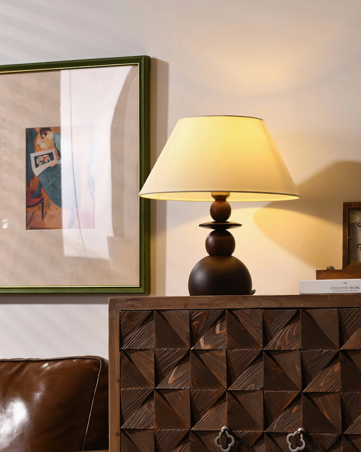Unlit walnut wood base table lamp with neutral fabric shade, three-quarter view of stacked wooden construction