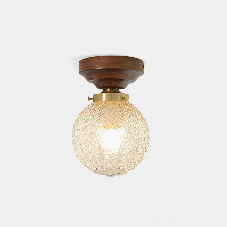 Walnut textured glass globe ceiling light fixture with brass accents, front studio view showcasing embossed glass sphere and wooden canopy