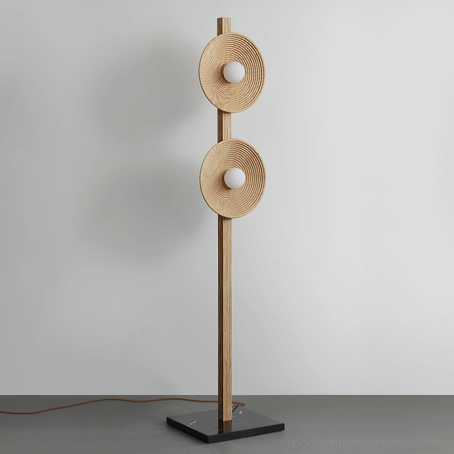 Walnut wood twin disc floor lamp front angle view with ribbed pole and warm brown tones