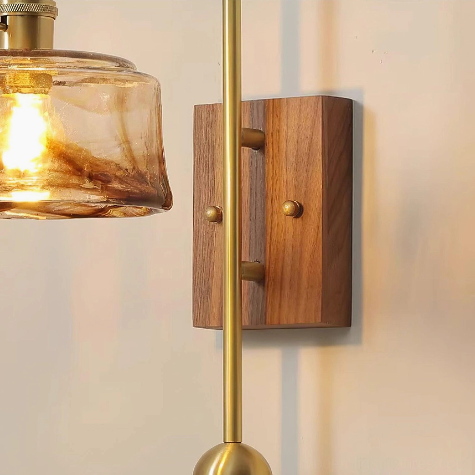 Walnut-finished wall sconce with geometric glass shade and functional brass counterweight