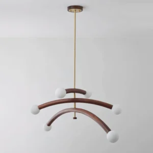 Sculptural wood chandelier with walnut and white finishes, six arms with matte globe diffusers on white backdrop